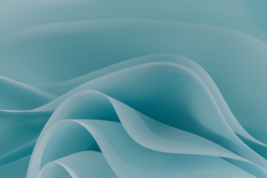 Smooth flowing teal waves with soft shadows and overlapping curves