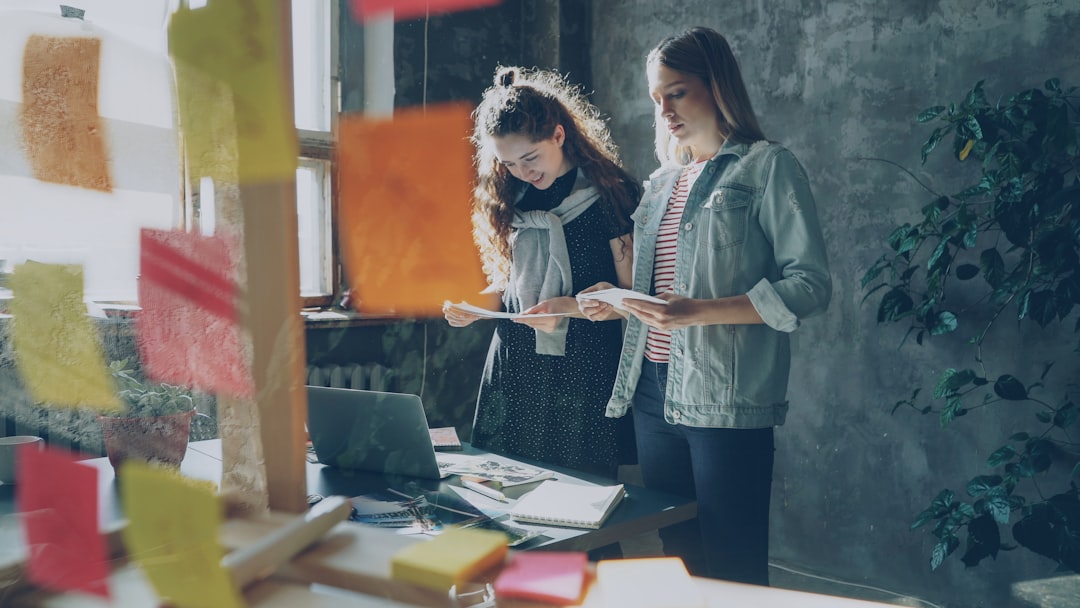 Two women work on a project in an office