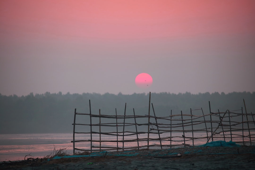 The sun is setting over a body of water